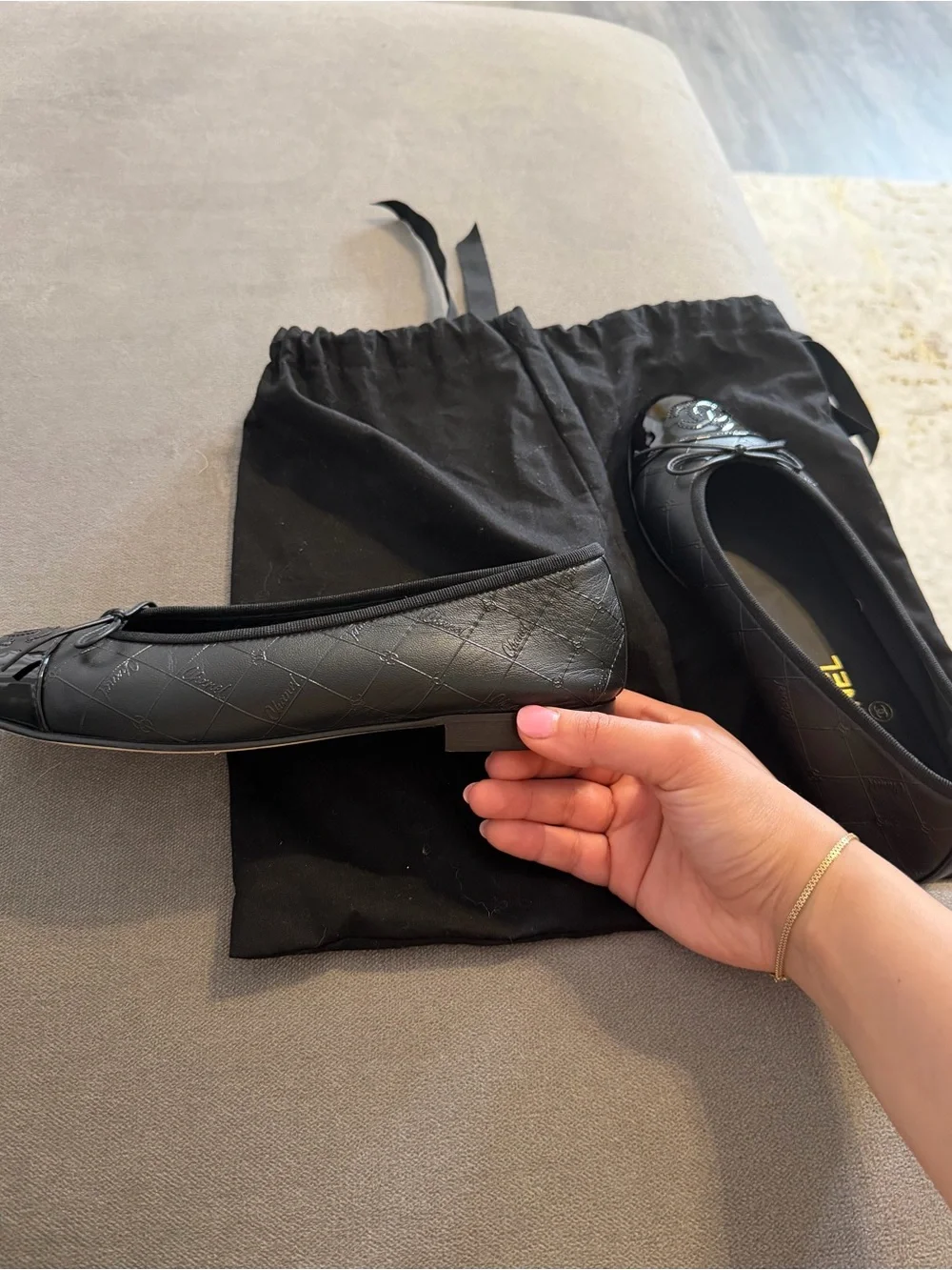 CHANEL Black Quilted Leather Cap-Toe Bow Ballet Flats